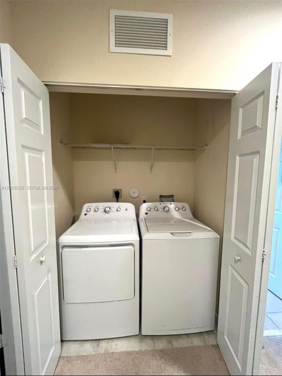 9401 Southwest 172nd Avenue, Unit 9401 Miami, FL 33196 - Photo 16 of 34 a utility room with dryer and washer