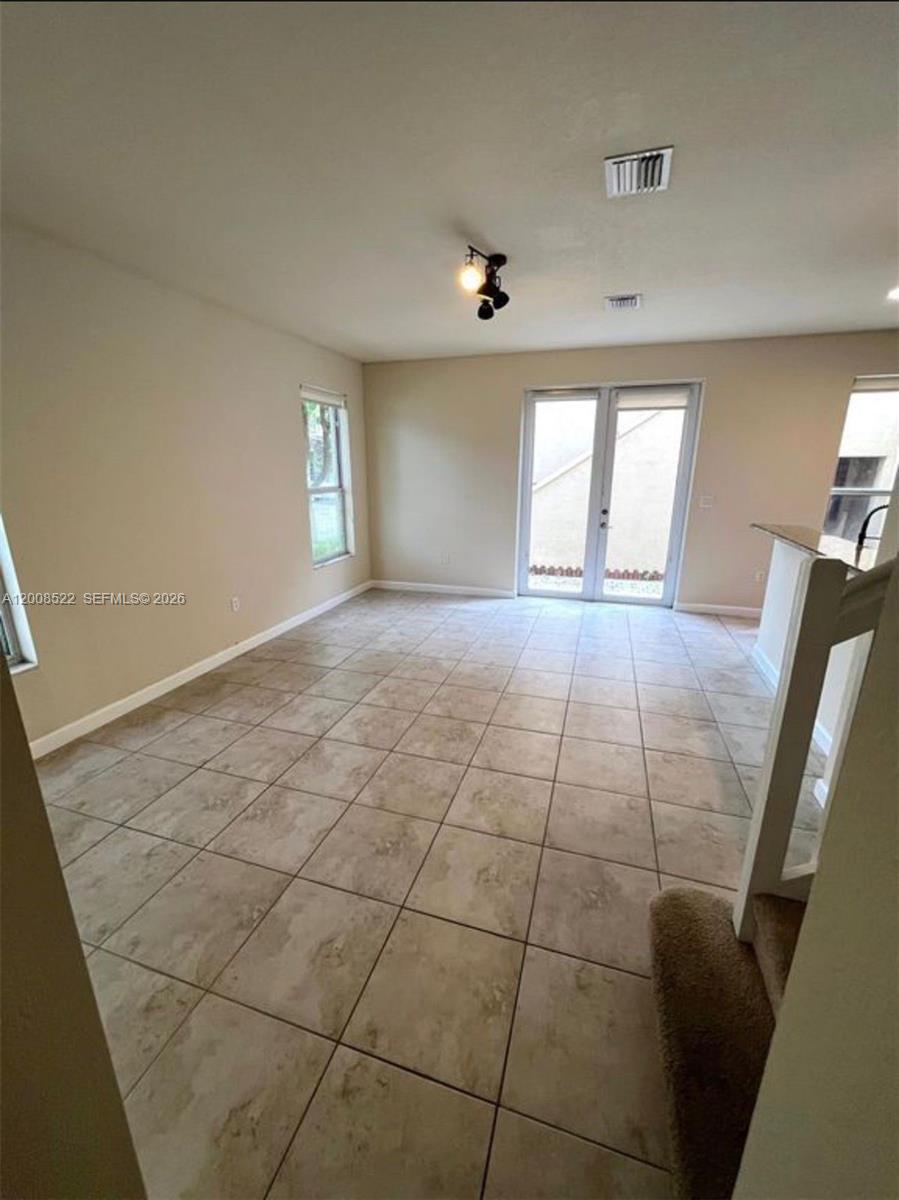 9401 Southwest 172nd Avenue, Unit 9401 Miami, FL 33196 - Photo 17 of 34 a view of an empty room and window