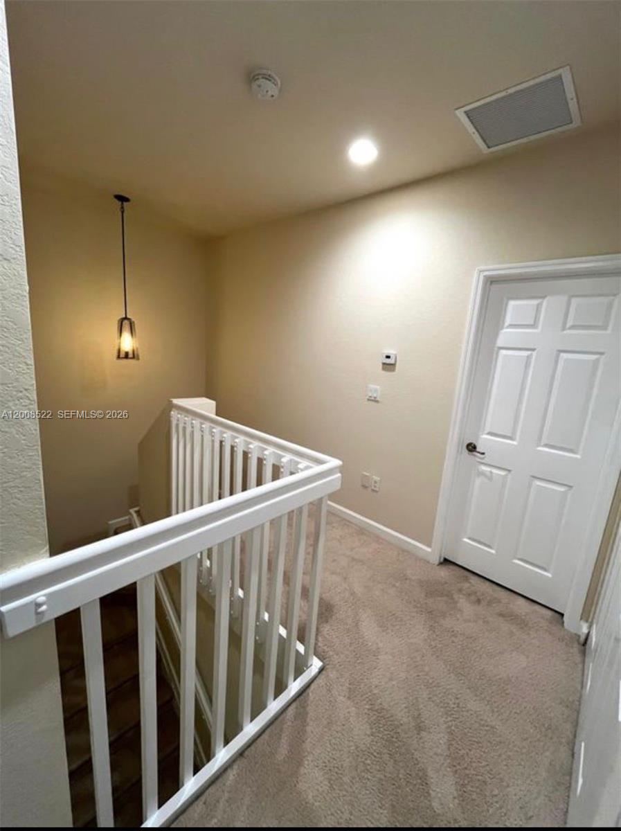 9401 Southwest 172nd Avenue, Unit 9401 Miami, FL 33196 - Photo 19 of 34 a view of an empty room with stairs