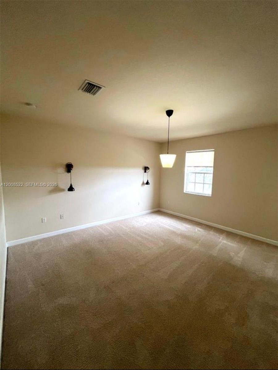 9401 Southwest 172nd Avenue, Unit 9401 Miami, FL 33196 - Photo 20 of 34 an empty room with windows and ceiling fan