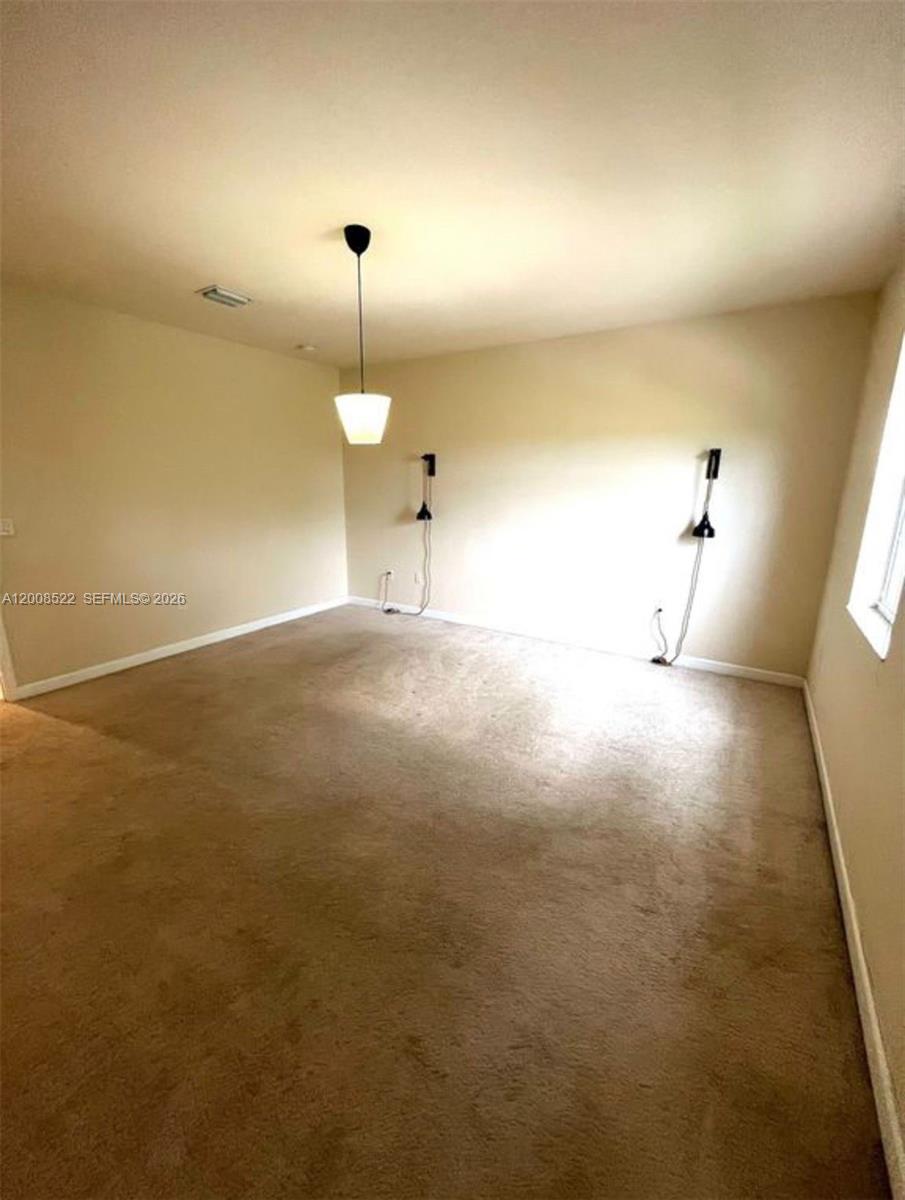 9401 Southwest 172nd Avenue, Unit 9401 Miami, FL 33196 - Photo 21 of 34 a view of empty room with a ceiling fan