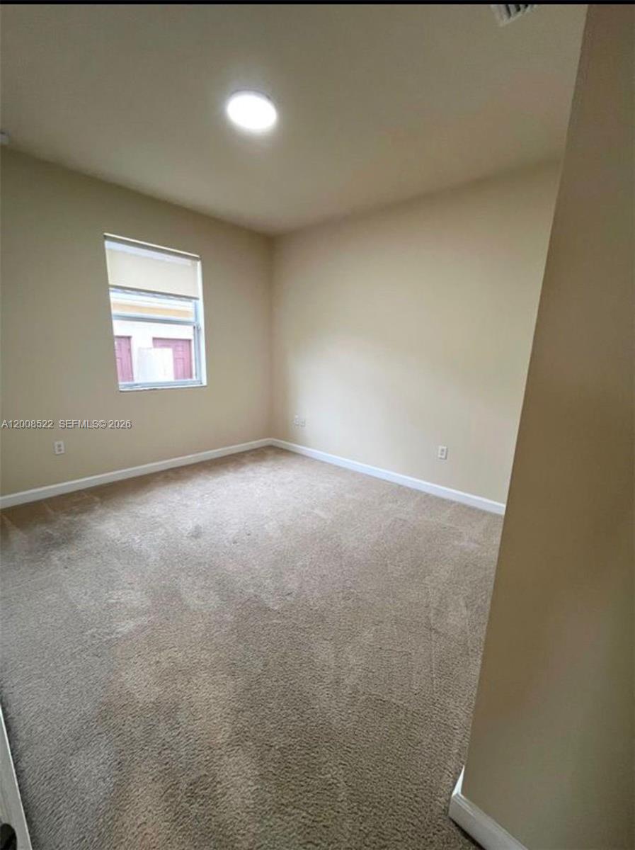 9401 Southwest 172nd Avenue, Unit 9401 Miami, FL 33196 - Photo 24 of 34 an empty room with a window