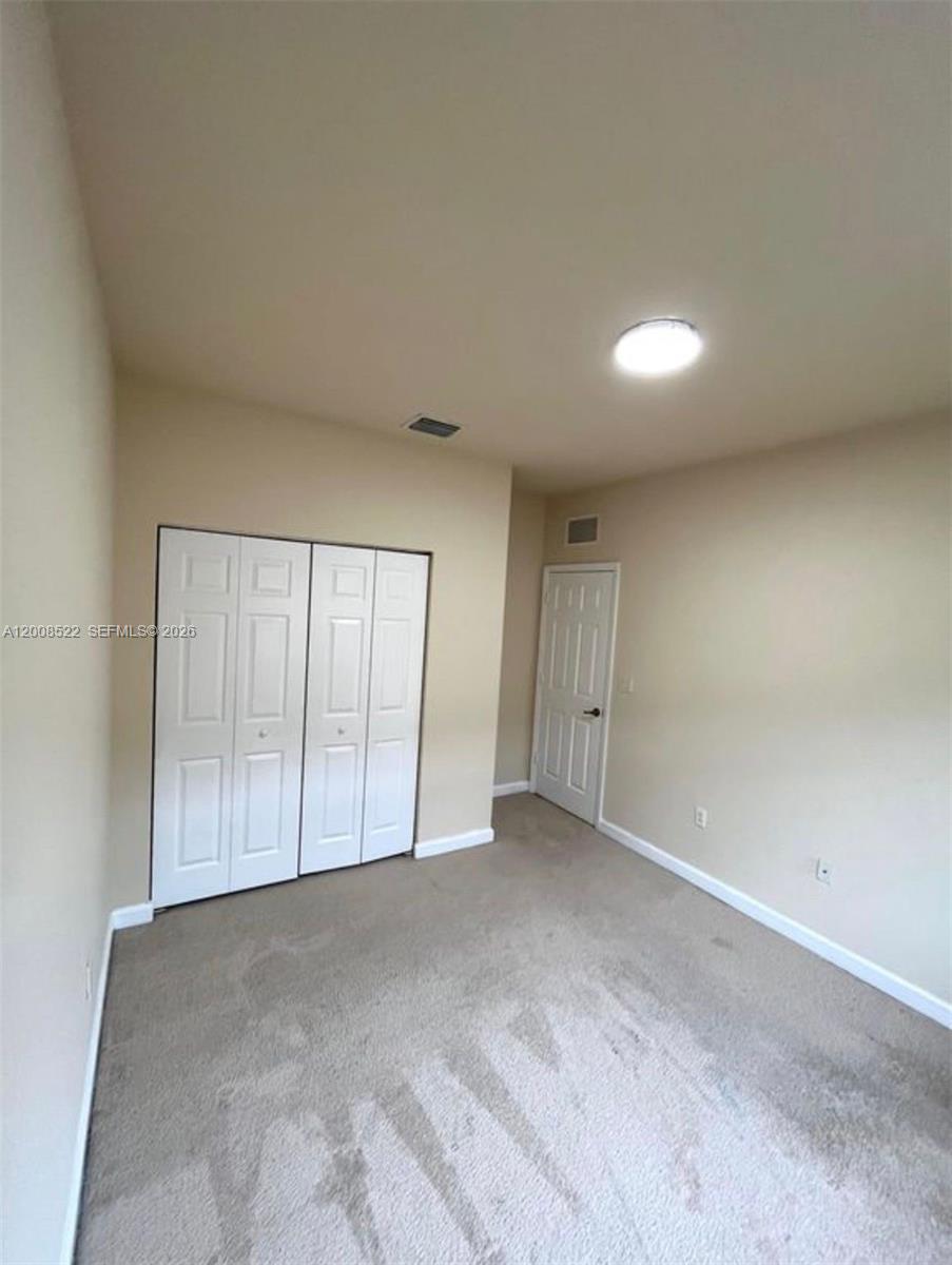 9401 Southwest 172nd Avenue, Unit 9401 Miami, FL 33196 - Photo 25 of 34 a view of an empty room with a window
