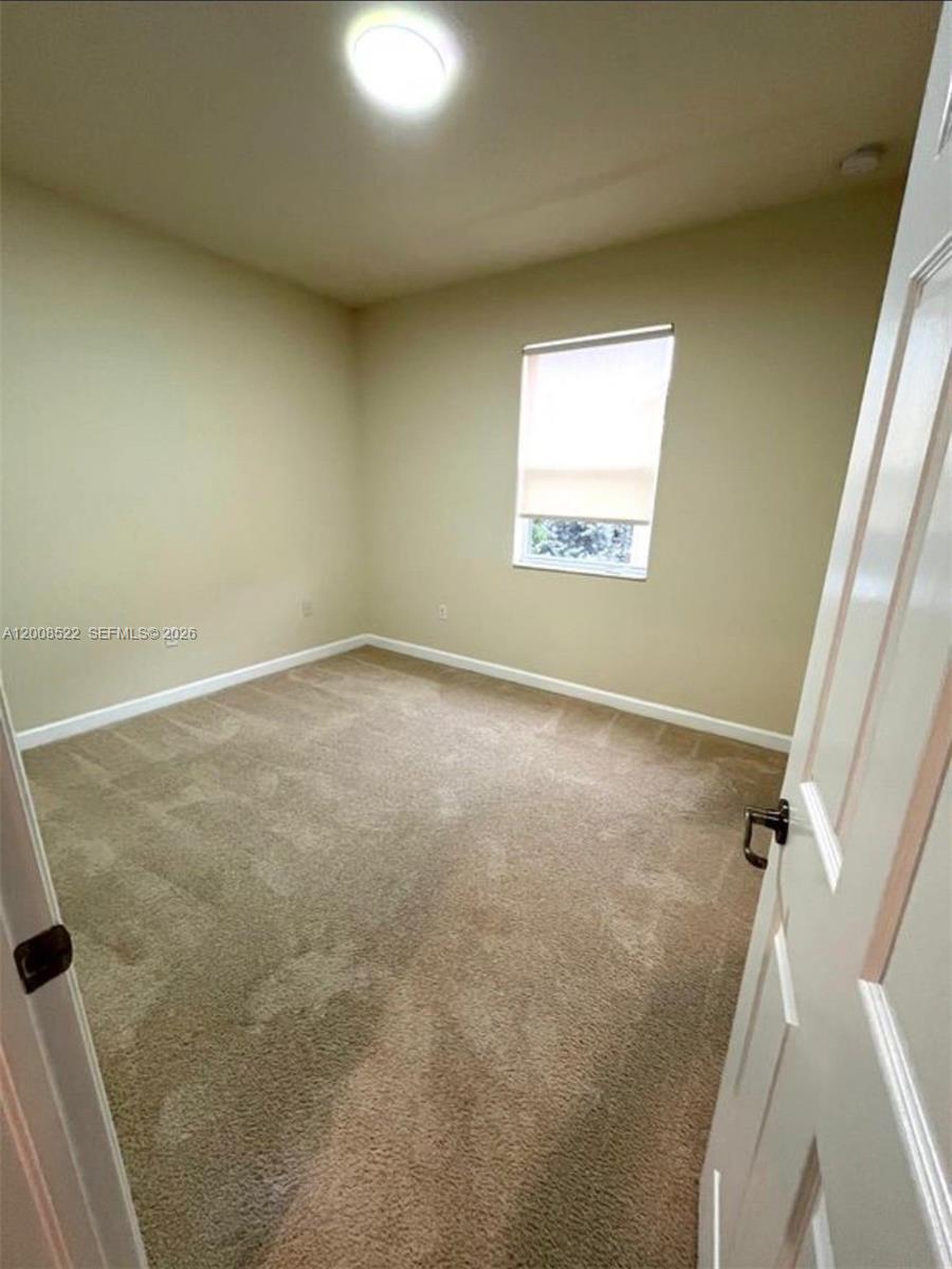 9401 Southwest 172nd Avenue, Unit 9401 Miami, FL 33196 - Photo 26 of 34 an empty room with a window