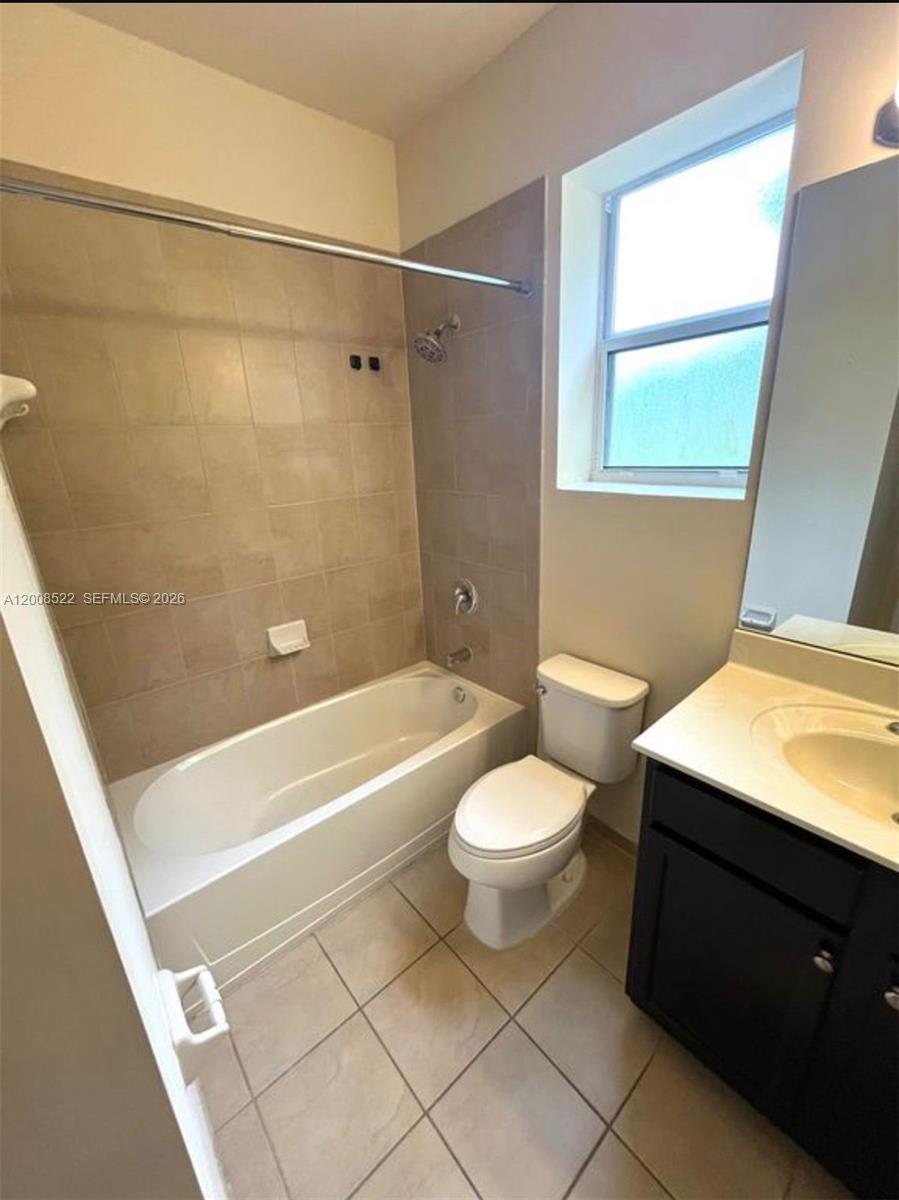 9401 Southwest 172nd Avenue, Unit 9401 Miami, FL 33196 - Photo 28 of 34 a bathroom with a toilet a sink and bathtub