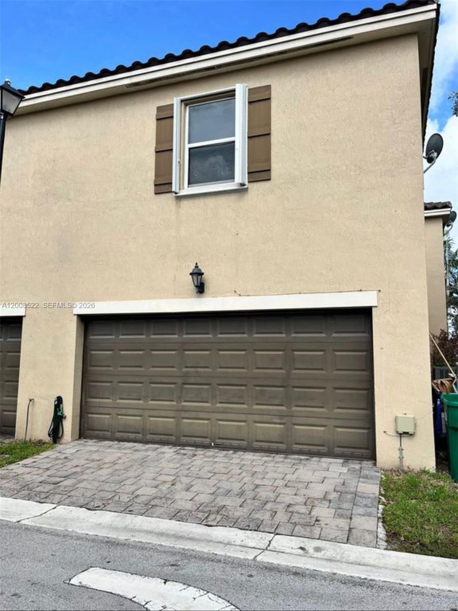 9401 Southwest 172nd Avenue, Unit 9401 Miami, FL 33196 - Photo 30 of 34 a front view of a house with garage