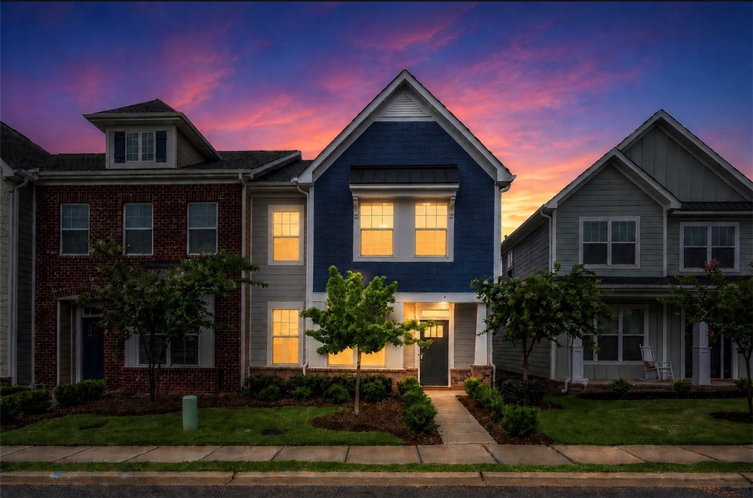 8 Leander Drive Greer, SC 29651 - Photo 2 of 31 Twilight paints the sky above a row of inviting townhomes, each with unique character.