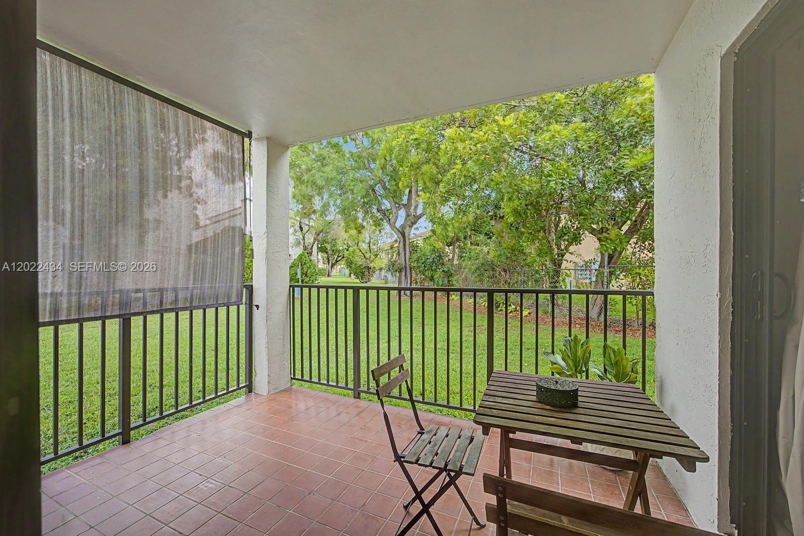 13045 Southwest 68th Street, Unit 111 Miami, FL 33183 - Photo 7 of 15 a view of a balcony with wooden floor