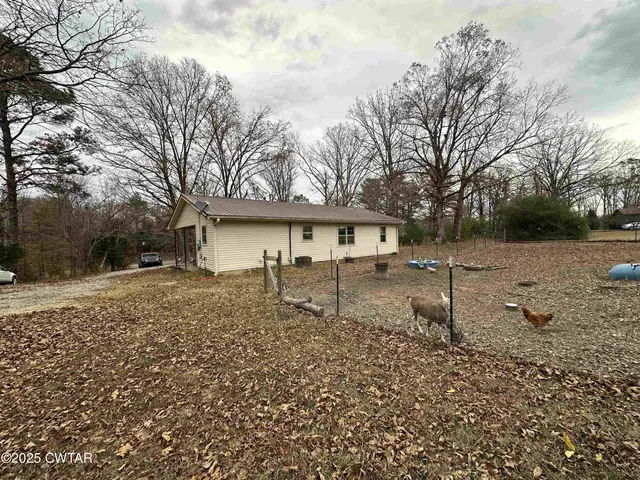 a living room with furniture ceiling fan and a window