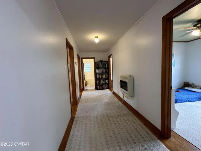 a bedroom with two beds and a chair