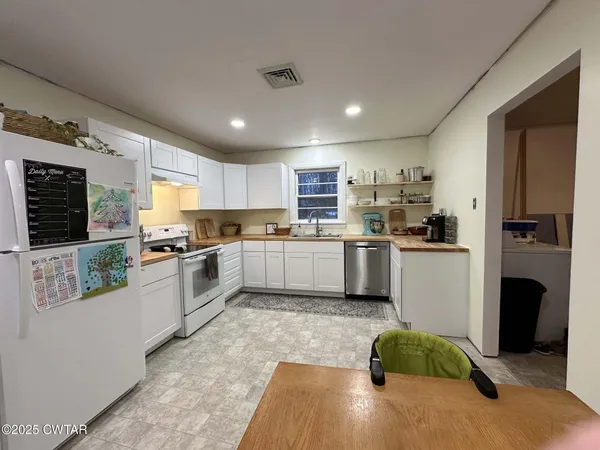 a kitchen with a sink stainless steel appliances and cabinets