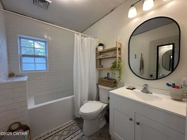 a large spacious bedroom with a large bed and a window