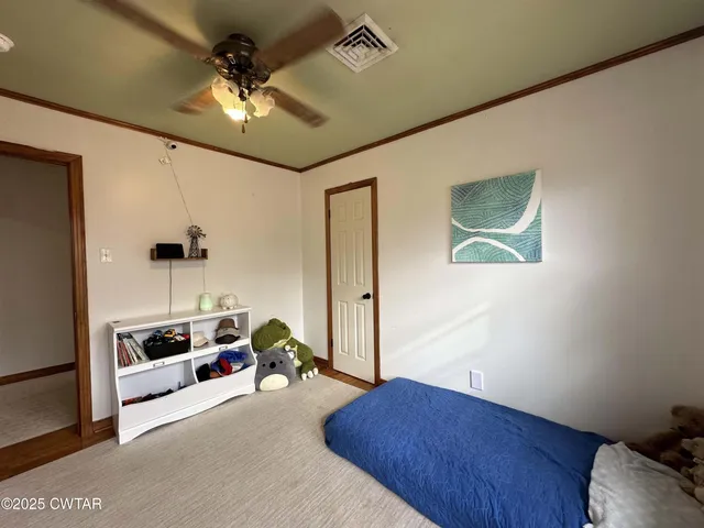 a view of storage and utility room with refrigerator and washer