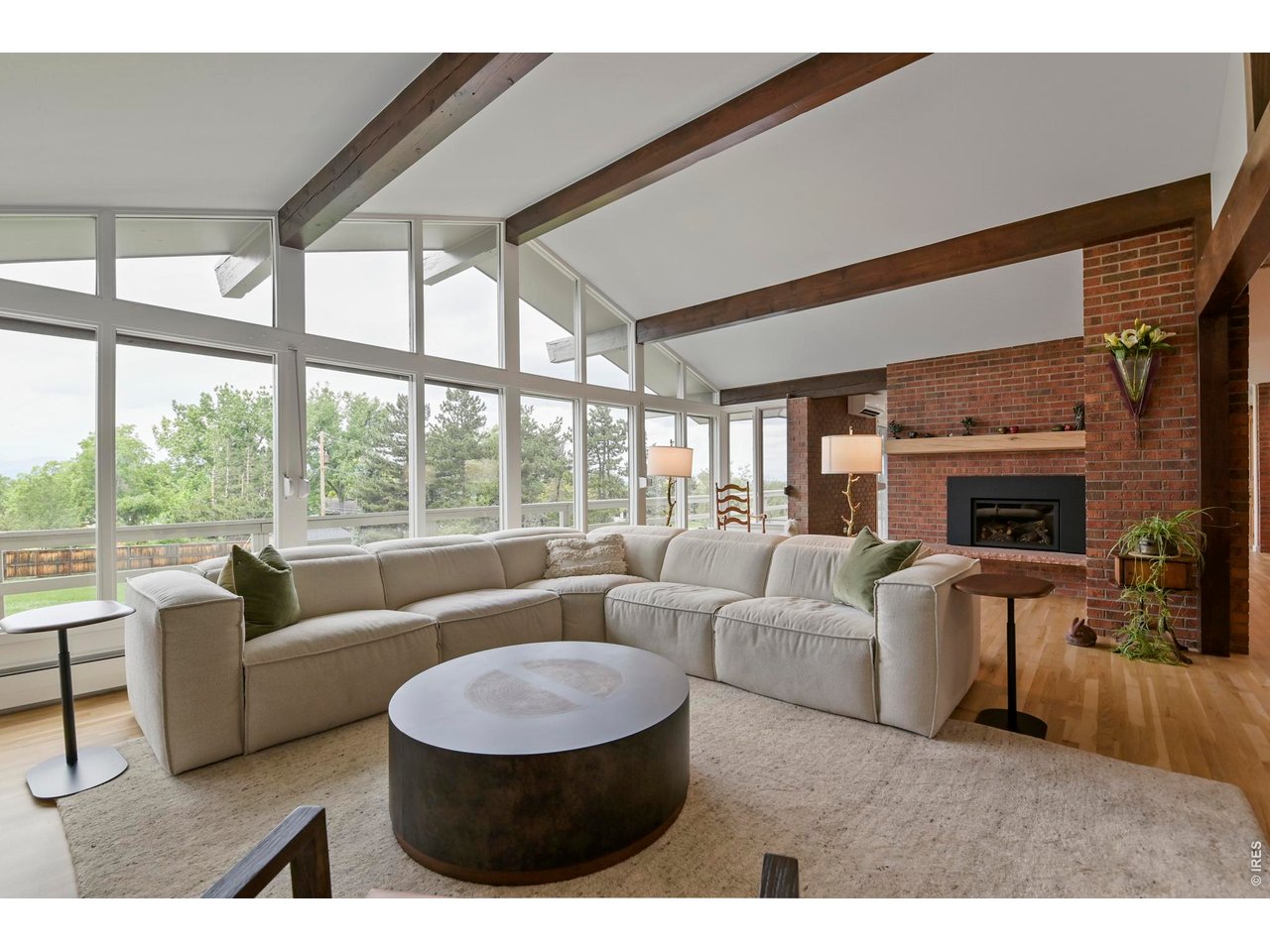 19 Ridge Road Boulder, CO 80303 - Photo 12 of 49 Spacious living room with solid wood beam ceilling, a brick gas fireplace and white oak mantle.