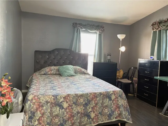a bedroom with a bed and a dresser