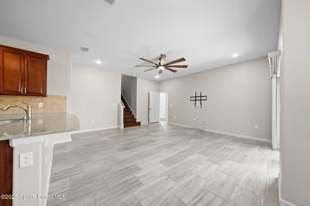 a bathroom with a granite countertop sink a toilet a bathtub and shower