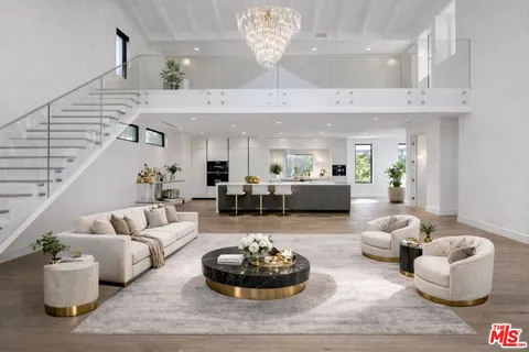 a living room with furniture and chandelier