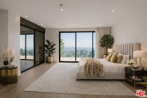 a spacious bedroom with a bed and a large window