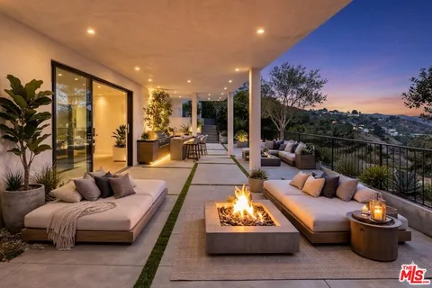 a living room with patio furniture and a floor to ceiling window