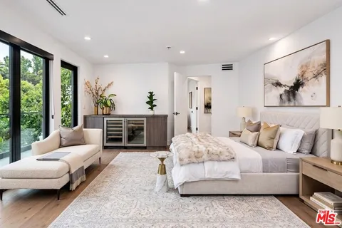 a living room with furniture and large windows