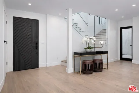 a view of kitchen with furniture and refrigerator