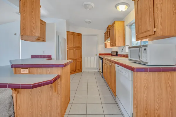 a kitchen with stainless steel appliances granite countertop a sink stove and cabinets