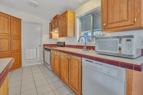 a kitchen with stainless steel appliances a sink stove and cabinets