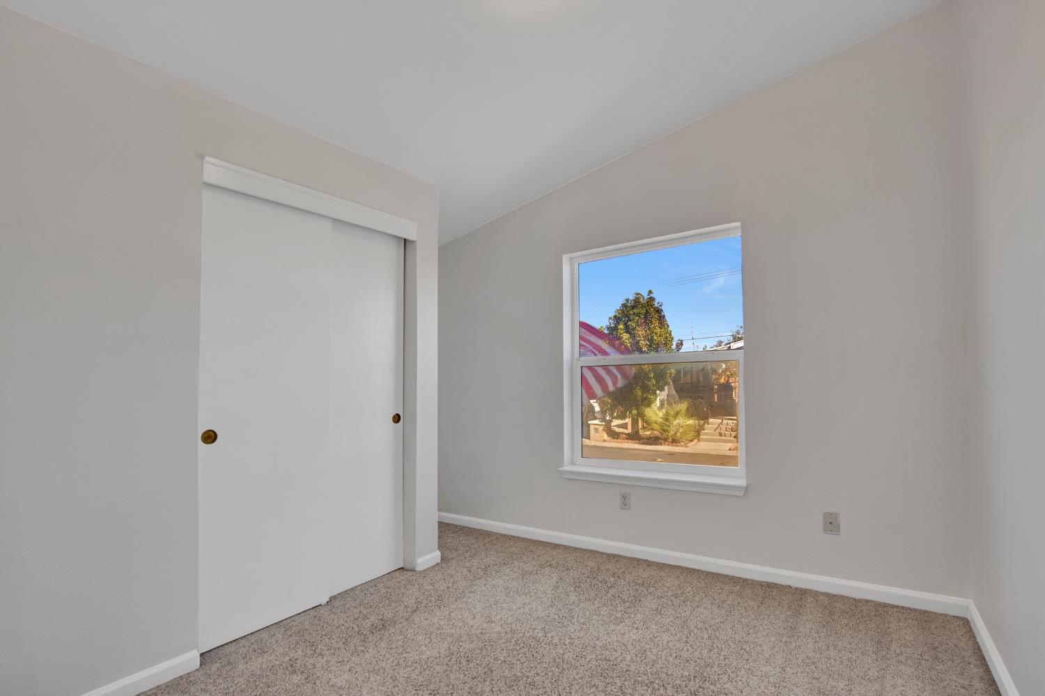 5130 County Road 99W, Unit 82 Dunnigan, CA 95937 - Photo 26 of 39 an empty room with painting and view of hallway