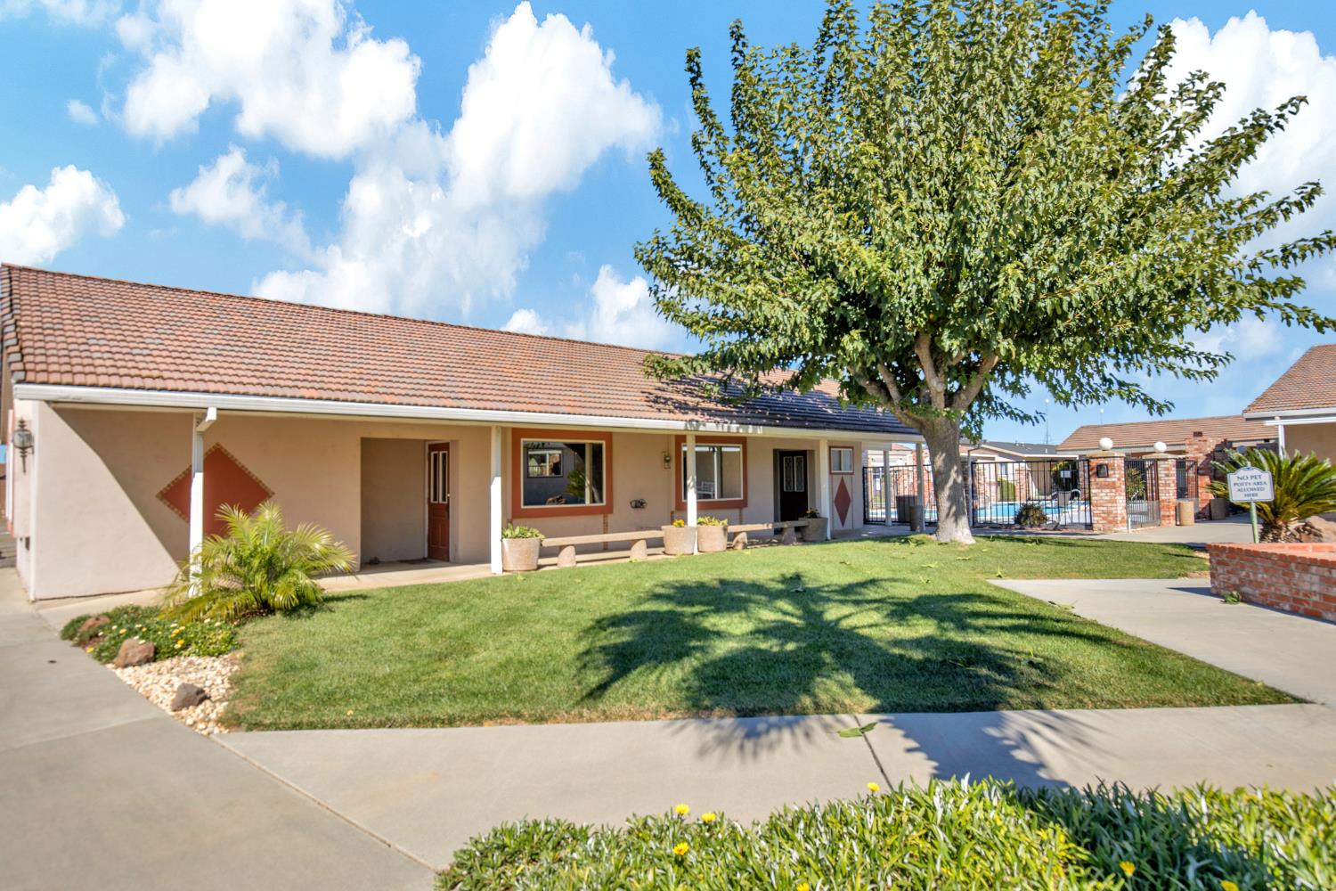 5130 County Road 99W, Unit 82 Dunnigan, CA 95937 - Photo 33 of 39 a front view of a house with a yard and potted plants