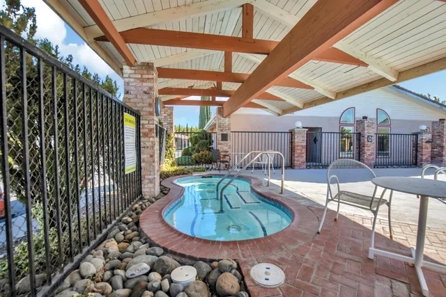 a view of a swimming pool with a seating space
