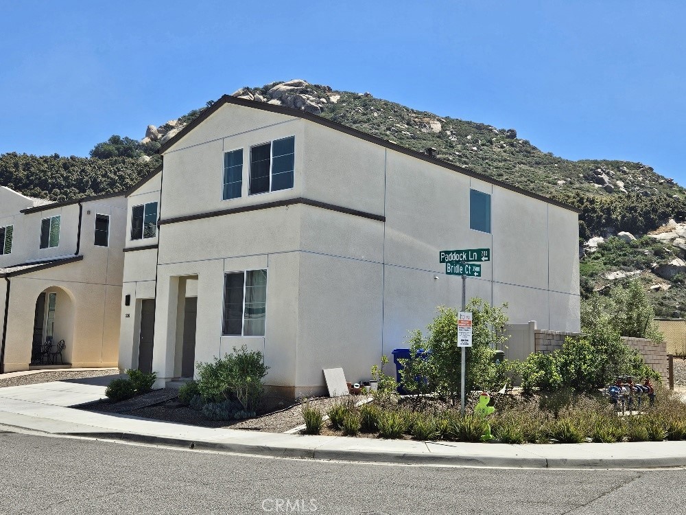 a front view of a house with plants