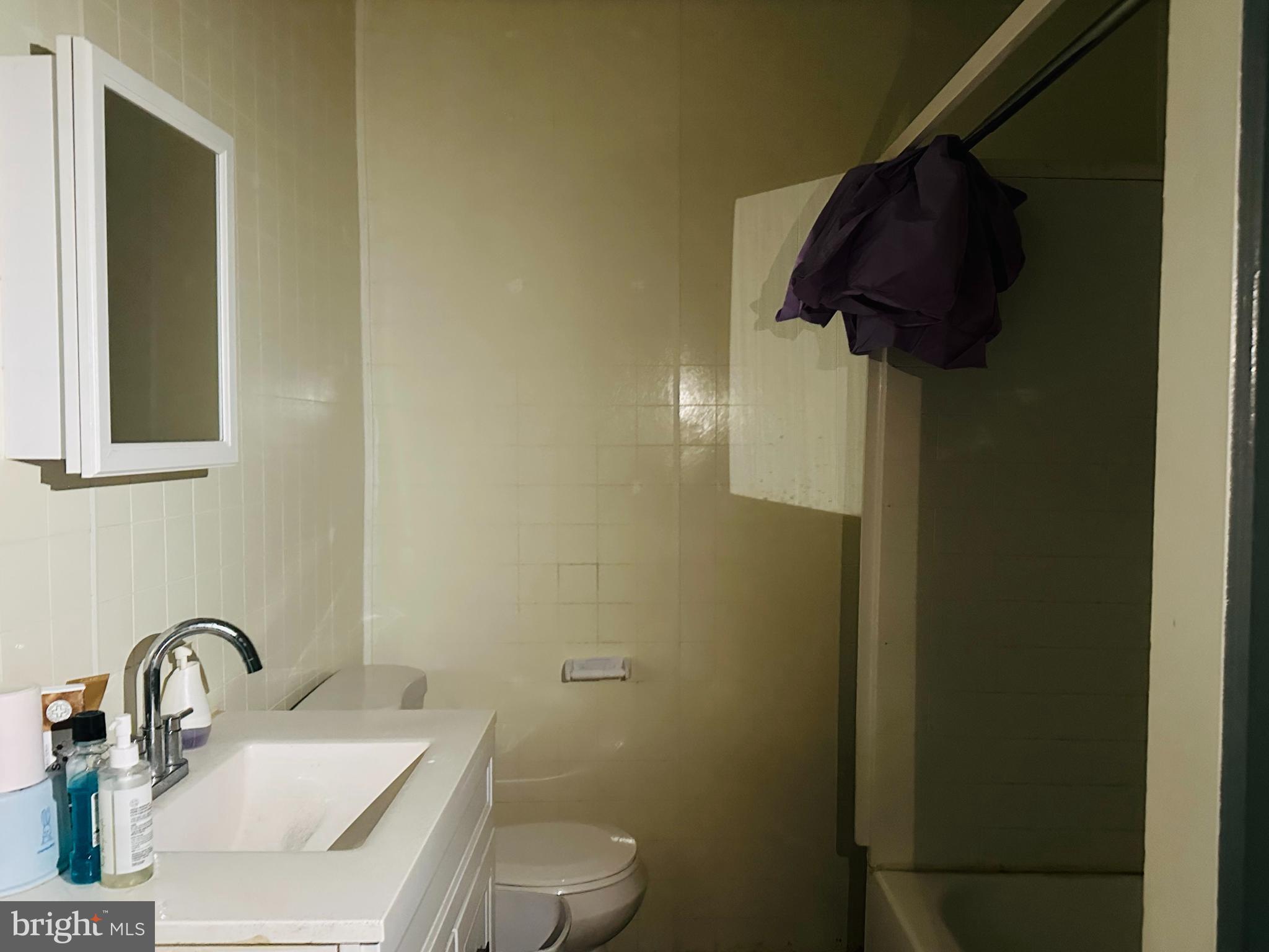 5227 North 3rd Street Philadelphia, PA 19120 - Photo 15 of 22 a bathroom with a sink toilet and vanity