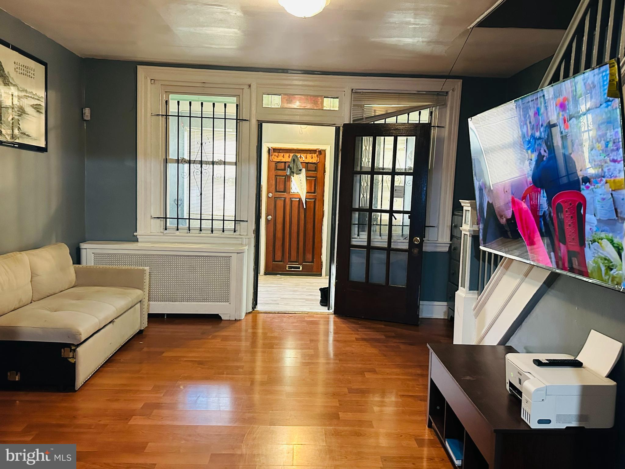 5227 North 3rd Street Philadelphia, PA 19120 - Photo 7 of 22 a living room with furniture and a flat screen tv