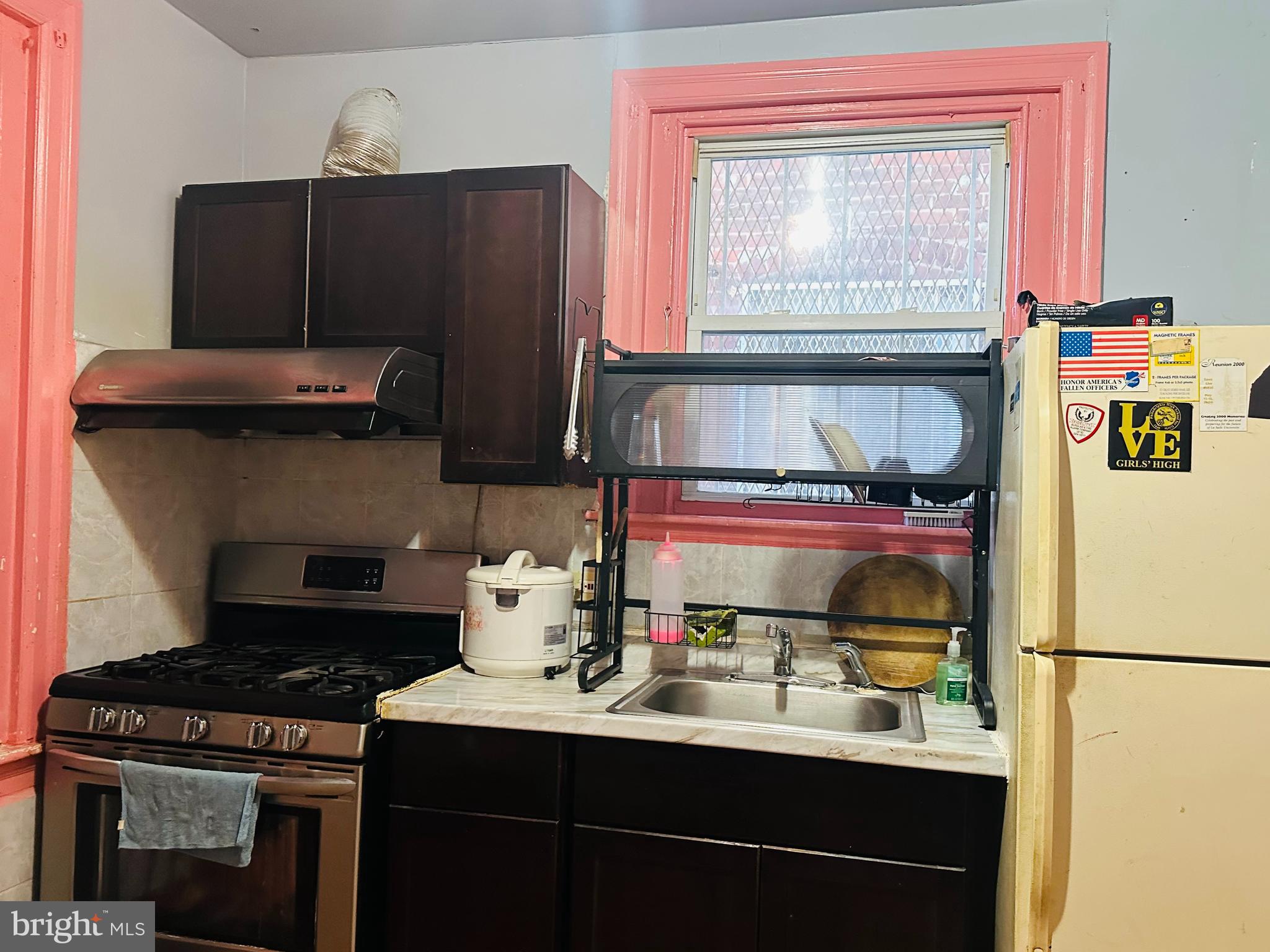5227 North 3rd Street Philadelphia, PA 19120 - Photo 8 of 22 a kitchen with a refrigerator and a stove