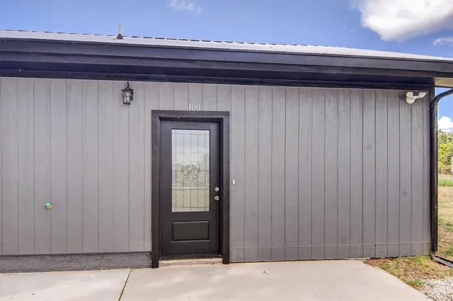a bathroom with a granite countertop sink and a toilet