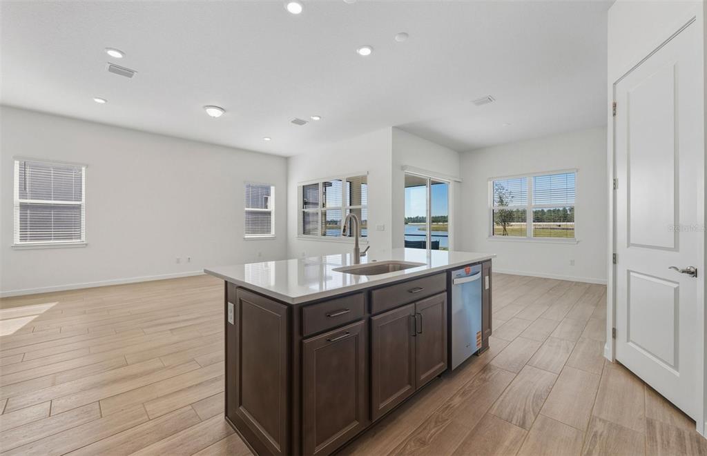 13647 Cyn Rdg Road Spring Hill, FL 34610 - Photo 3 of 29 a kitchen with granite countertop a stove and wooden floor