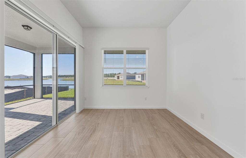 13647 Cyn Rdg Road Spring Hill, FL 34610 - Photo 6 of 30 wooden floor in an empty room with a window