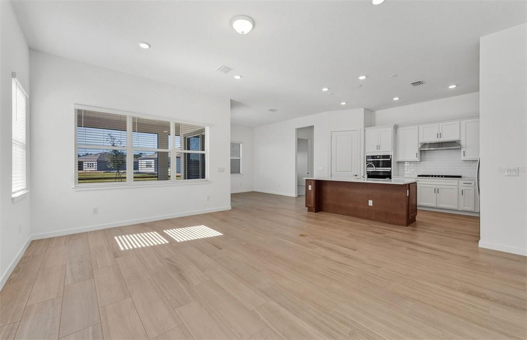 13647 Cyn Rdg Road Spring Hill, FL 34610 - Photo 8 of 29 a large kitchen with stainless steel appliances granite countertop a large counter top a wooden floors and a large window