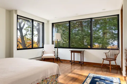 a bedroom with a large window and a bed