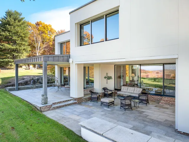 a view of a house with backyard porch and sitting area