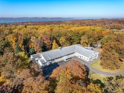 an aerial view of house with yard and ocean view