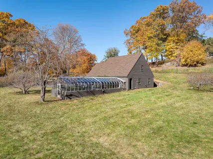 a view of a house with a yard and sitting area