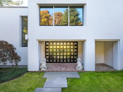 a front view of a house with a garden