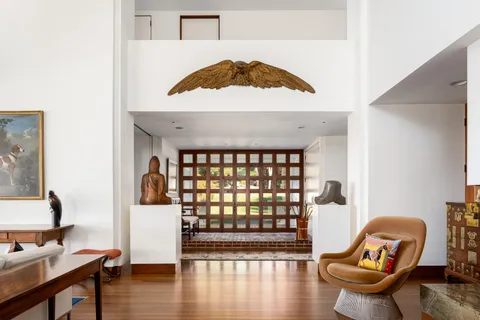 a view of a workspace with furniture and wooden floor