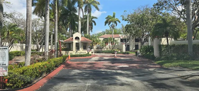 a front view of a house with yard and green space
