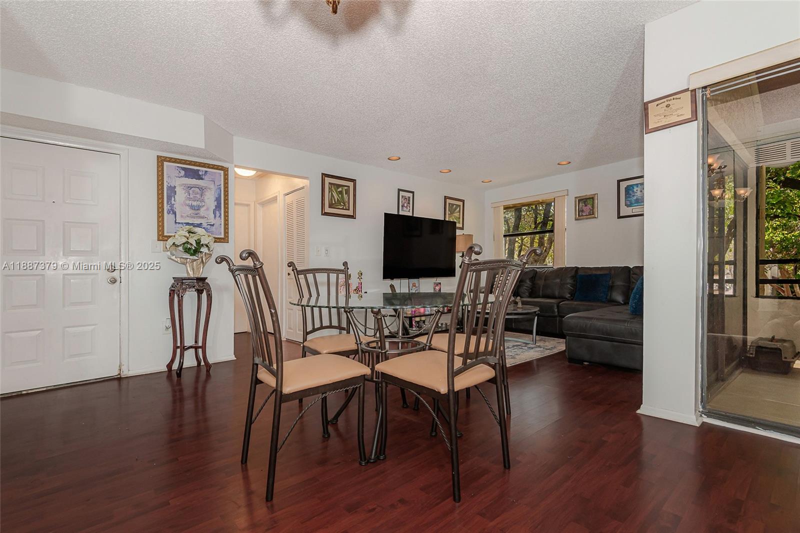 20015 Northeast 3rd Court, Unit 6 Miami, FL 33179 - Photo 11 of 31 a living room with furniture and a flat screen tv