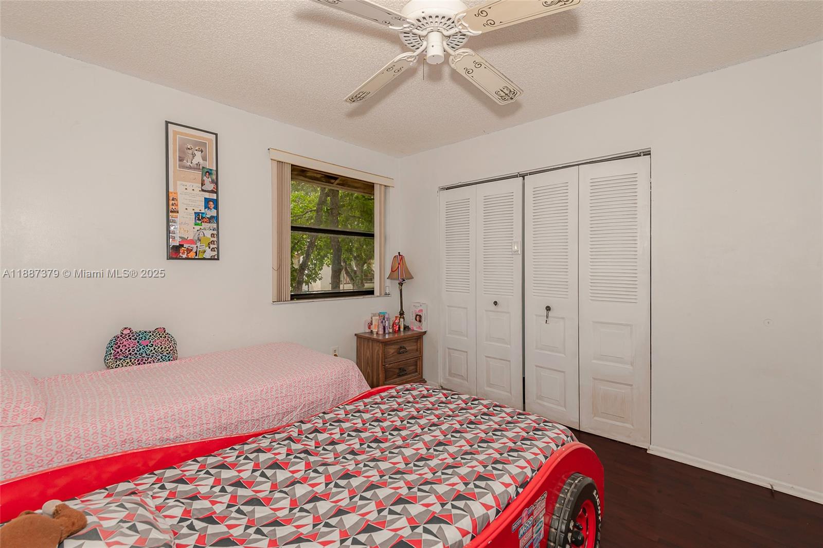 20015 Northeast 3rd Court, Unit 6 Miami, FL 33179 - Photo 18 of 31 a bedroom with a bed and a chandelier