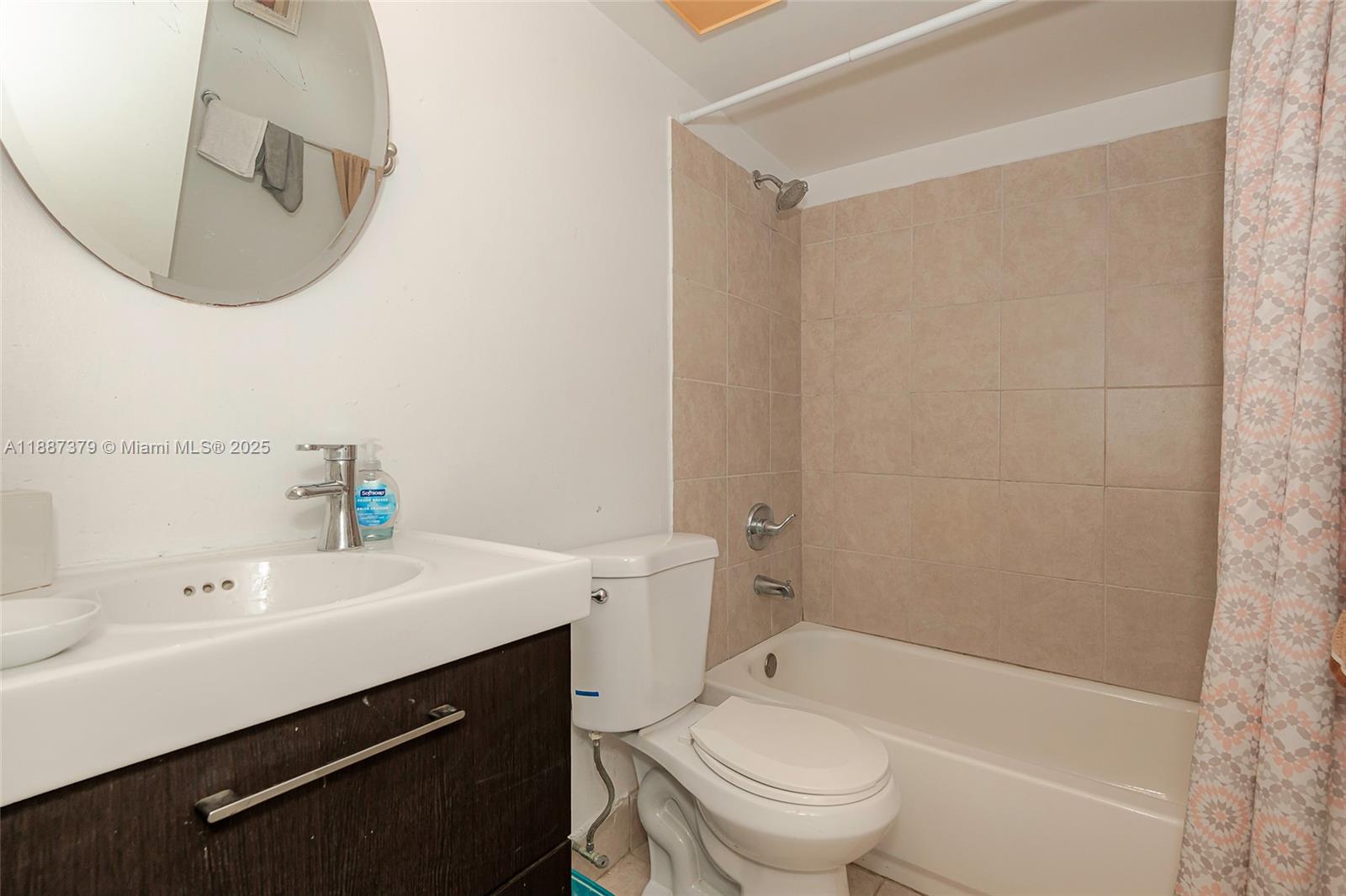 20015 Northeast 3rd Court, Unit 6 Miami, FL 33179 - Photo 19 of 31 a bathroom with a sink a toilet and shower