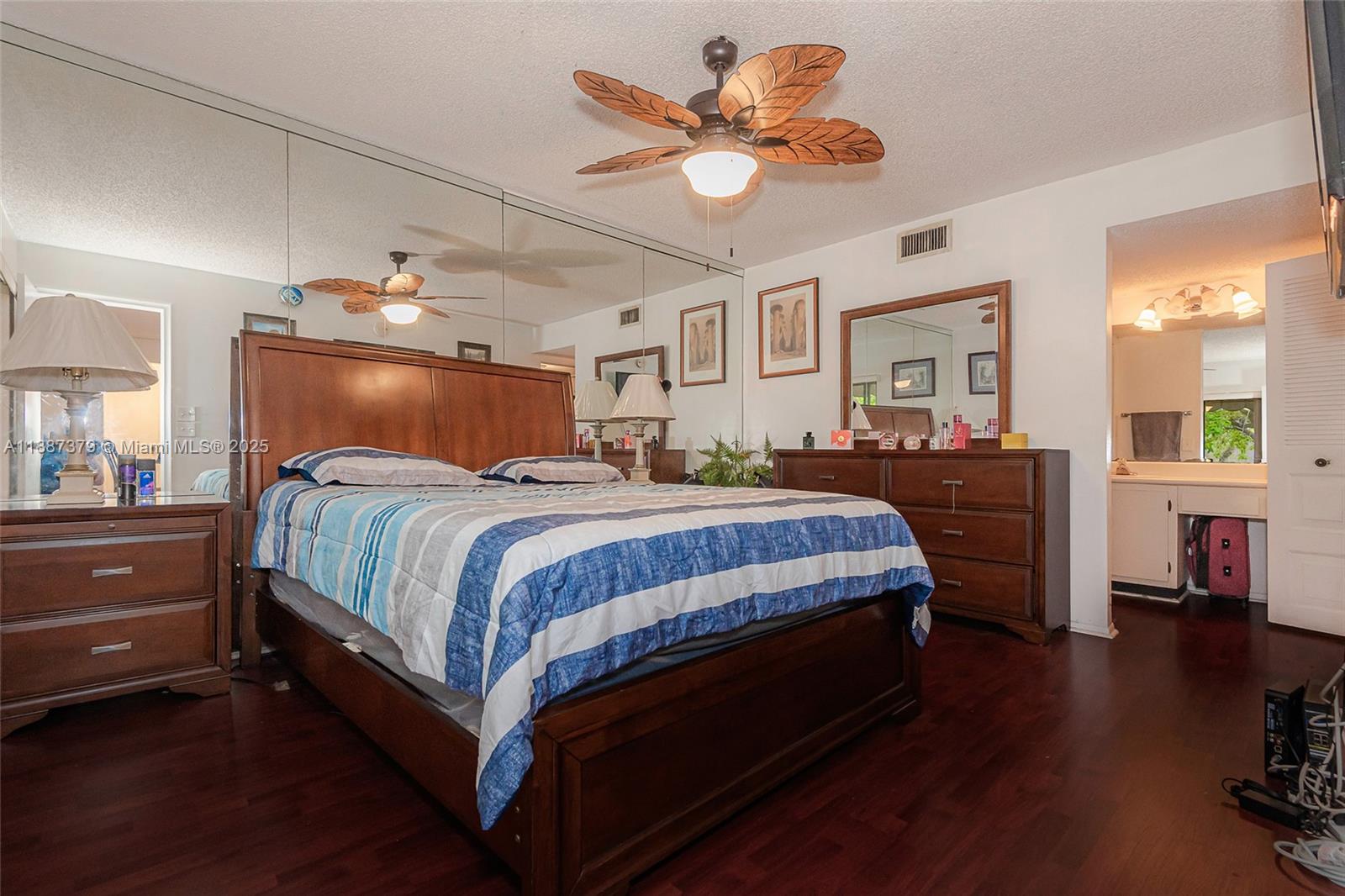 20015 Northeast 3rd Court, Unit 6 Miami, FL 33179 - Photo 20 of 31 a bedroom with a bed and wooden floor