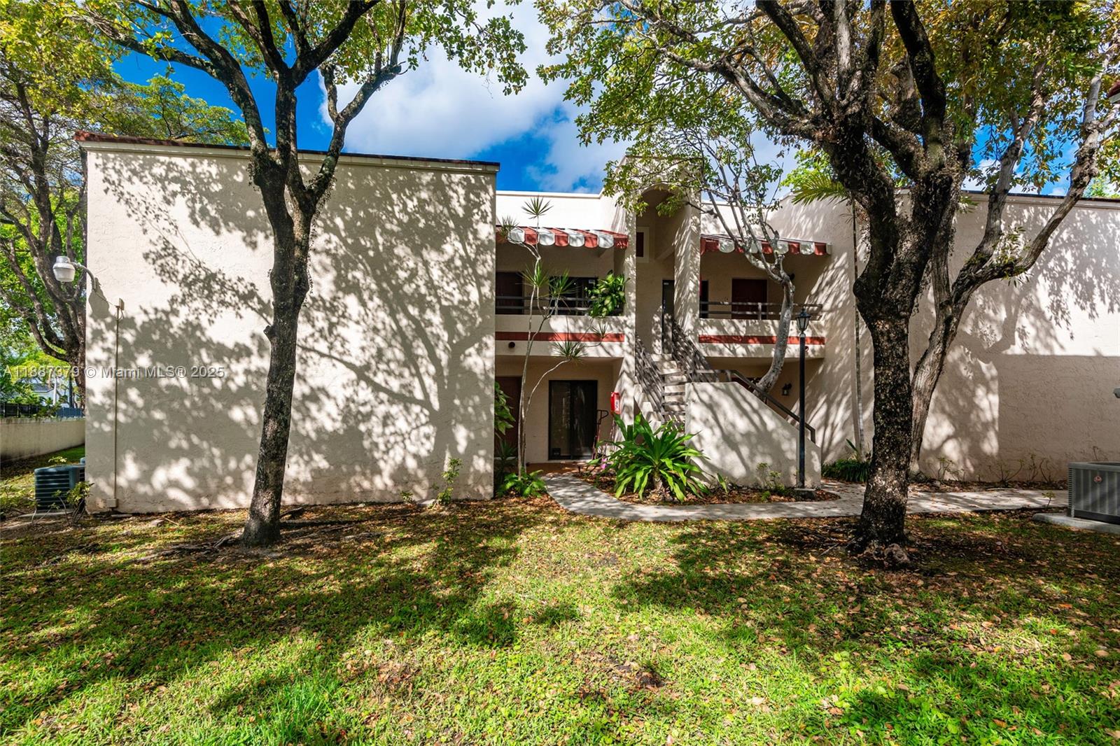 20015 Northeast 3rd Court, Unit 6 Miami, FL 33179 - Photo 2 of 31 a view of a house with a tree in the yard